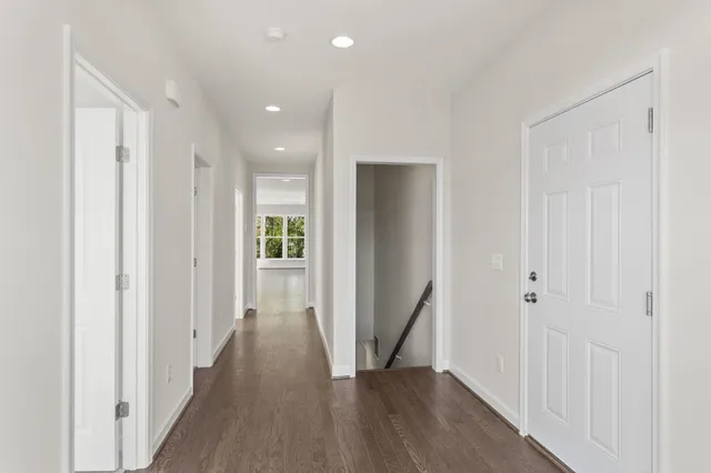 a view of an empty room with closet and a window