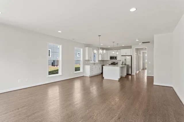 a view of a kitchen with a sink and wooden floor
