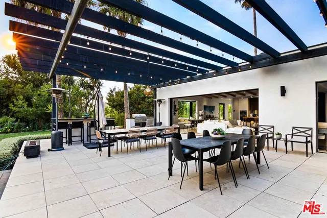 a view of a patio with table and chairs and potted plants