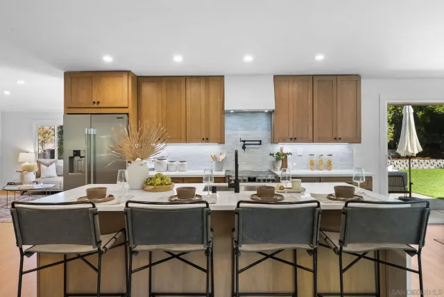 a dining room with furniture and a kitchen view