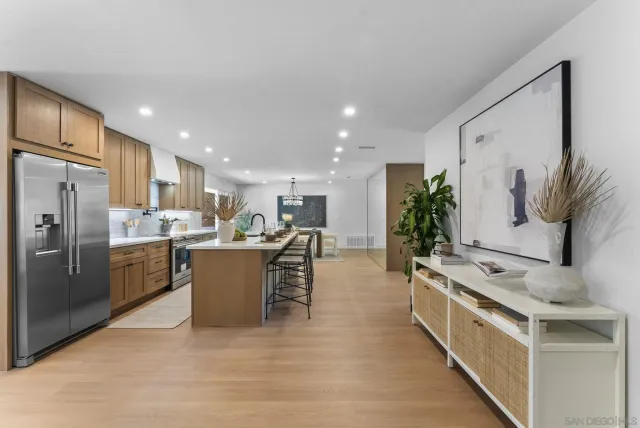 a large white kitchen with stainless steel appliances