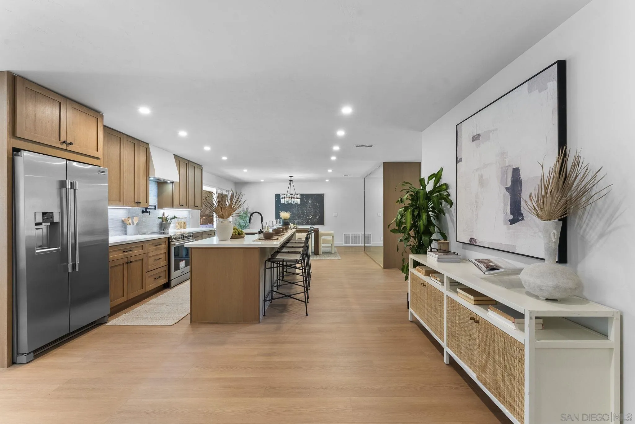 12830 Avenida La Valencia Poway, CA 92064 - Photo 12 of 47 a large white kitchen with stainless steel appliances