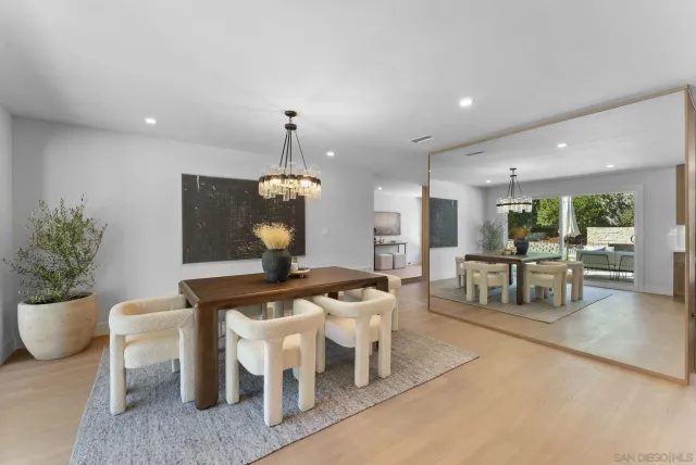 a dining room with furniture and a chandelier