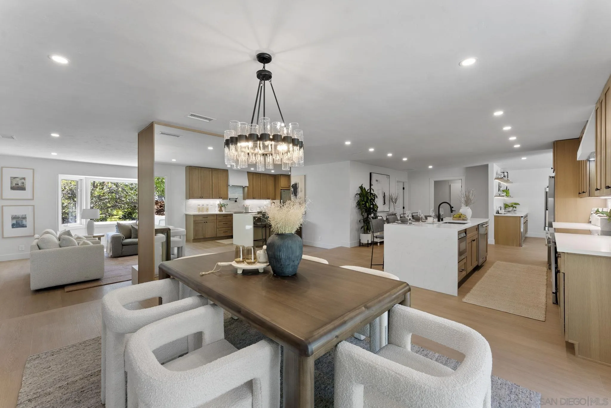 12830 Avenida La Valencia Poway, CA 92064 - Photo 16 of 47 a view of a dining room and livingroom with furniture wooden floor a chandelier
