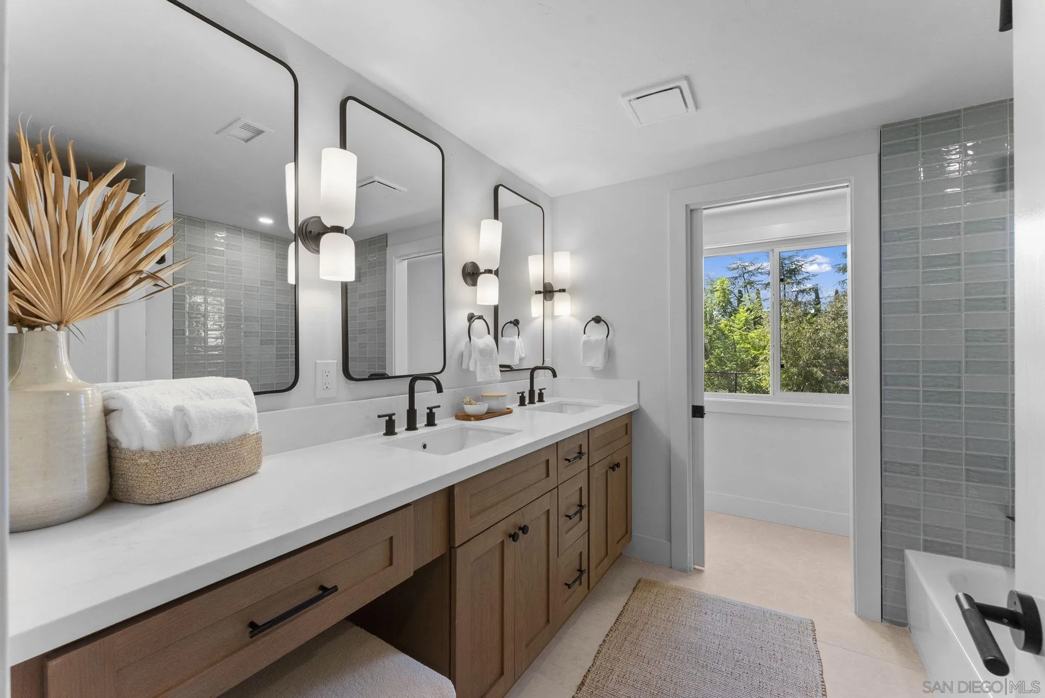 12830 Avenida La Valencia Poway, CA 92064 - Photo 26 of 47 a bathroom with a double vanity sink and a mirror