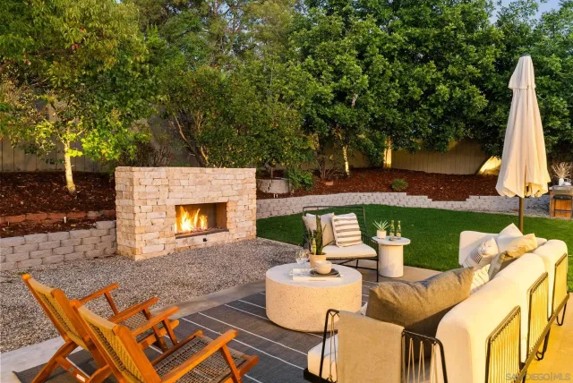 a view of a patio with a dining table and chairs with two couches