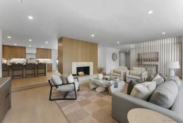 a living room with furniture fireplace and a table