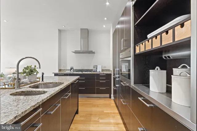 a large kitchen with stainless steel appliances granite countertop a sink stove and cabinets