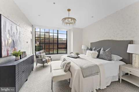 a bedroom with bed and a window