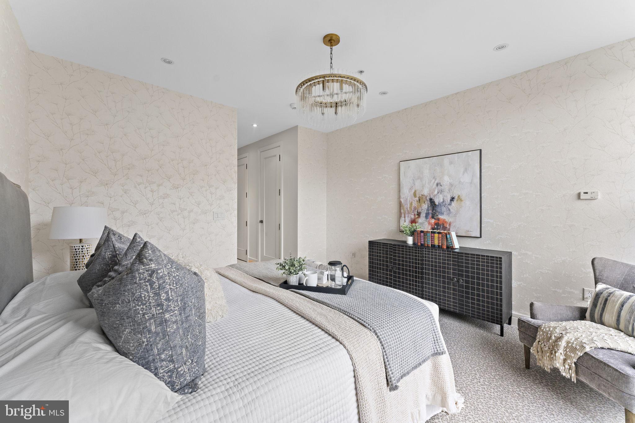 3303 Water Street Northwest, Unit 4L Washington, DC 20007 - Photo 18 of 60 a bedroom with a bed and ceiling fan