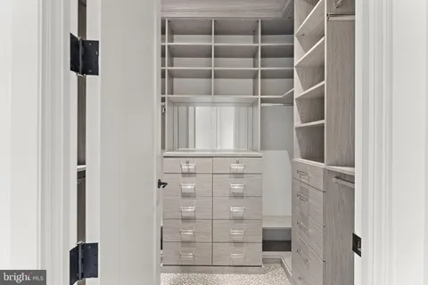 a view of walk in closet with empty racks