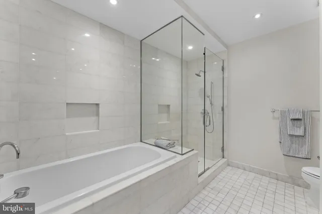 a bathroom with a bathtub a toilet and a shower