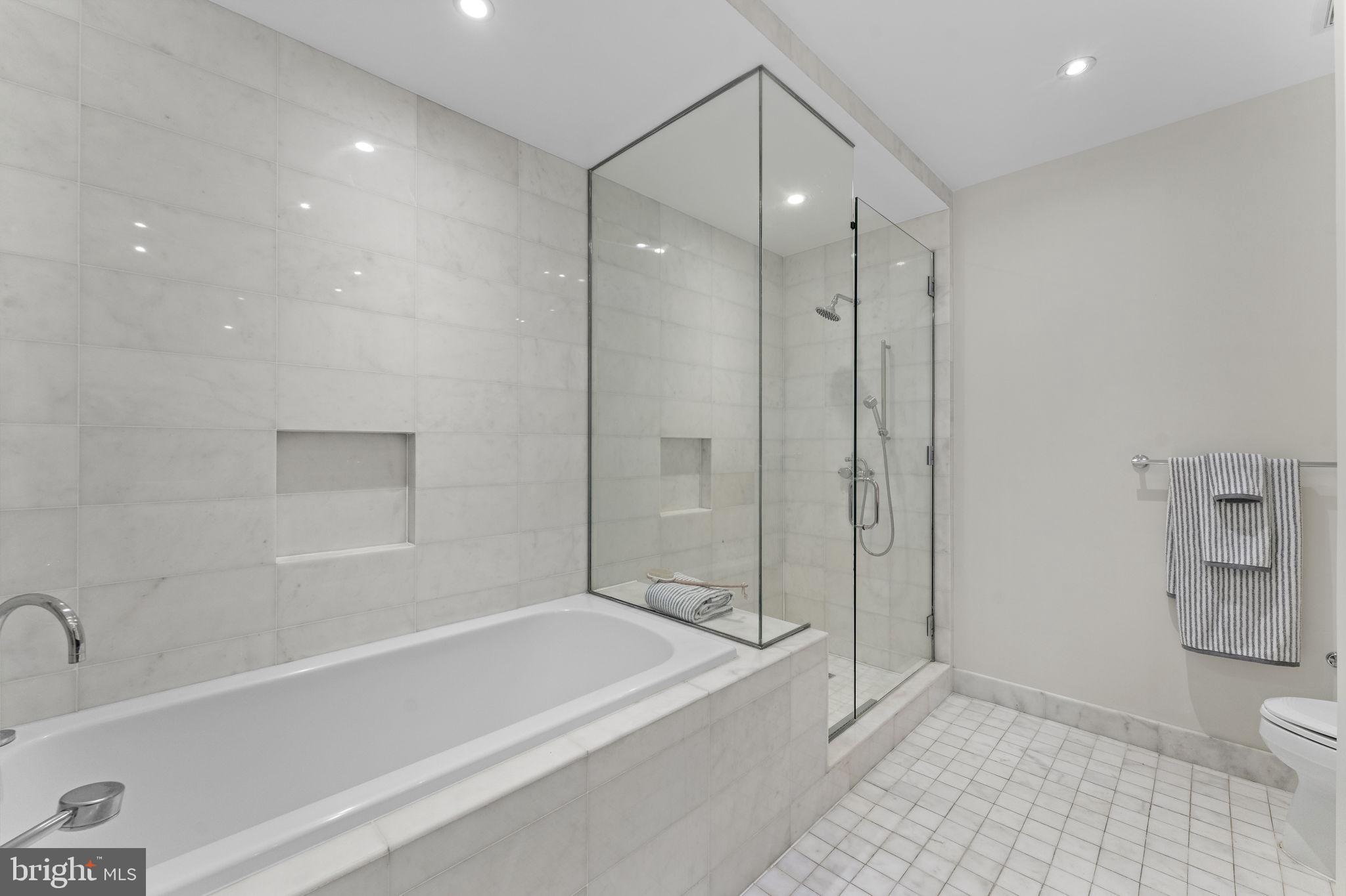 3303 Water Street Northwest, Unit 4L Washington, DC 20007 - Photo 22 of 60 a bathroom with a bathtub a toilet and a shower