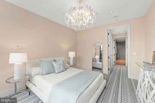 a bedroom with a bed and a chandelier