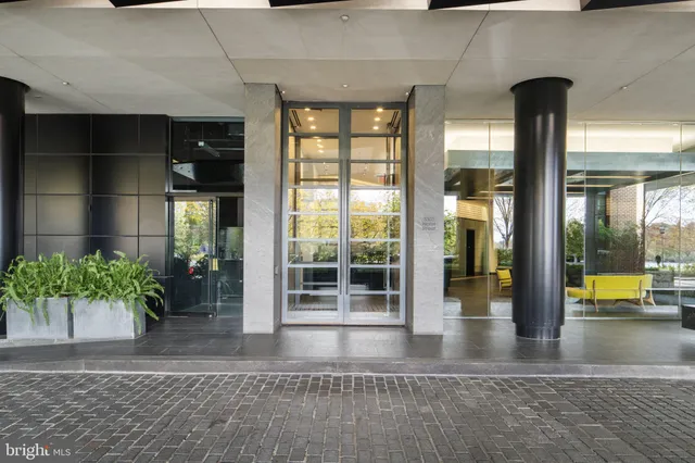 a view of lobby with a potted plant and floor to ceiling window