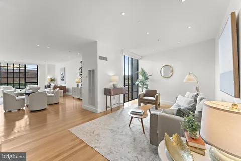 a living room with fireplace furniture and a wooden floor
