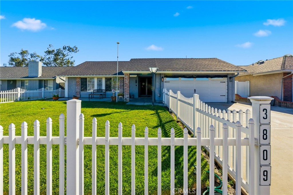 a view of a house with wooden fence