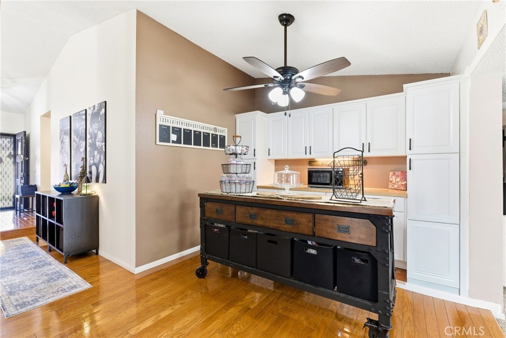 3809 Kern Road Chino, CA 91710 - Photo 13 of 43 a kitchen with stainless steel appliances granite countertop a refrigerator a sink dishwasher a stove and a dining table with wooden floor