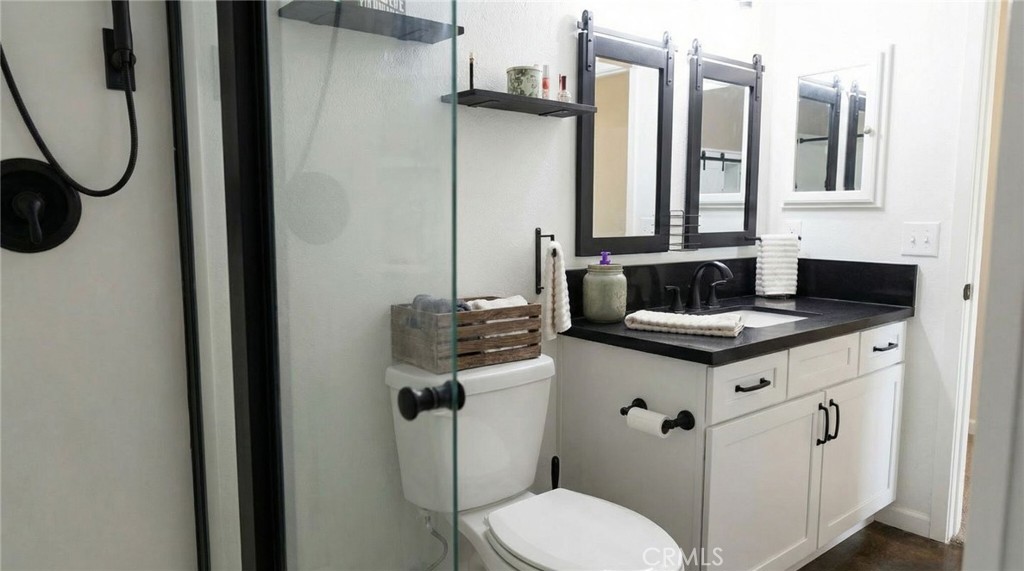 3809 Kern Road Chino, CA 91710 - Photo 26 of 43 a bathroom with a granite countertop toilet sink and mirror