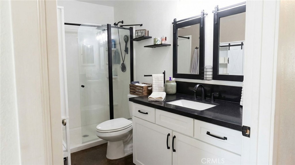 3809 Kern Road Chino, CA 91710 - Photo 27 of 43 a bathroom with a granite countertop sink toilet and shower