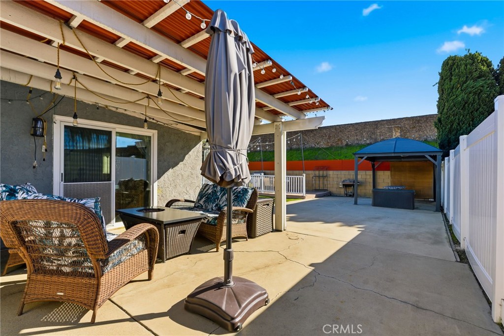 3809 Kern Road Chino, CA 91710 - Photo 29 of 43 a view of a patio with table and chairs with wooden floor and fence