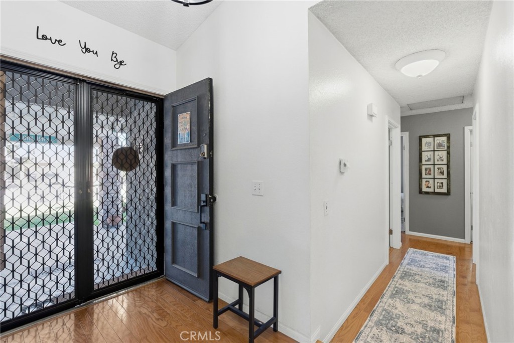 3809 Kern Road Chino, CA 91710 - Photo 5 of 43 a view of a hallway with wooden floor and entryway