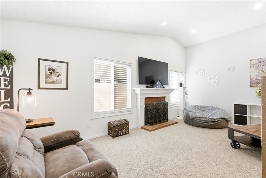 3809 Kern Road Chino, CA 91710 - Photo 7 of 43 a living room with furniture a flat screen tv and a fireplace