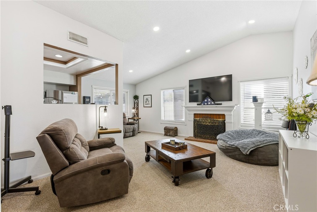 3809 Kern Road Chino, CA 91710 - Photo 8 of 43 a living room with furniture a flat screen tv and a fireplace