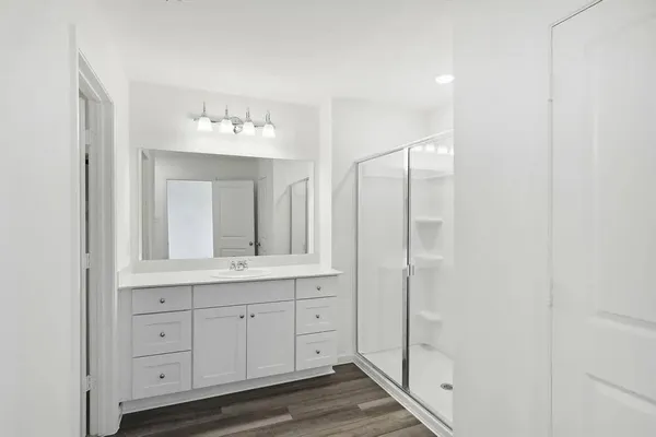 a bathroom with a granite countertop sink two mirror and a