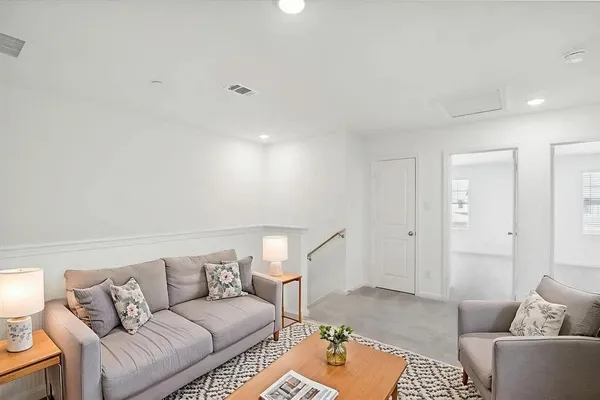 a living room with furniture and a rug