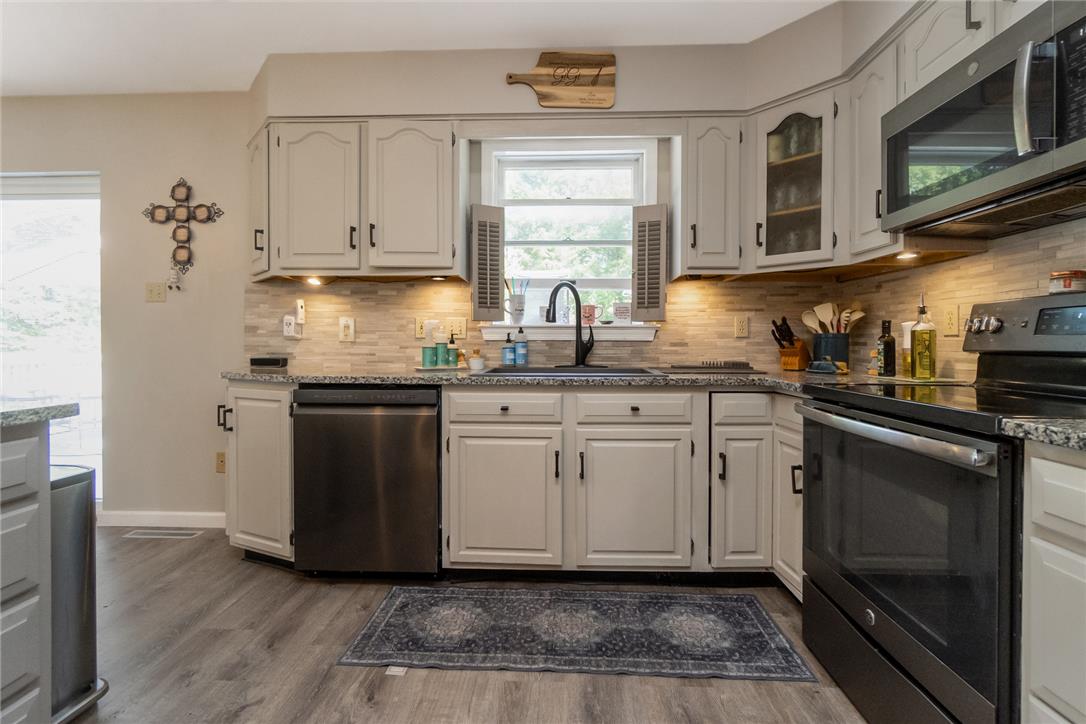 9461 Red Road Kempton, PA 19529 - Photo 8 of 55 A well-appointed kitchen features ample counter space, modern appliances, and soft under-cabinet lighting.