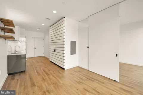 a view of a kitchen with a sink and dishwasher wooden floor