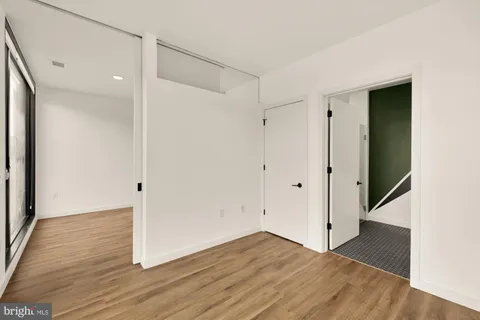 a view of empty room with wooden floor