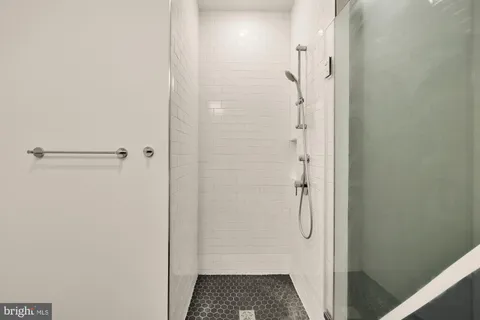 a living room with furniture and floor to ceiling windows