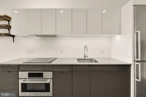 a kitchen with a sink and cabinets