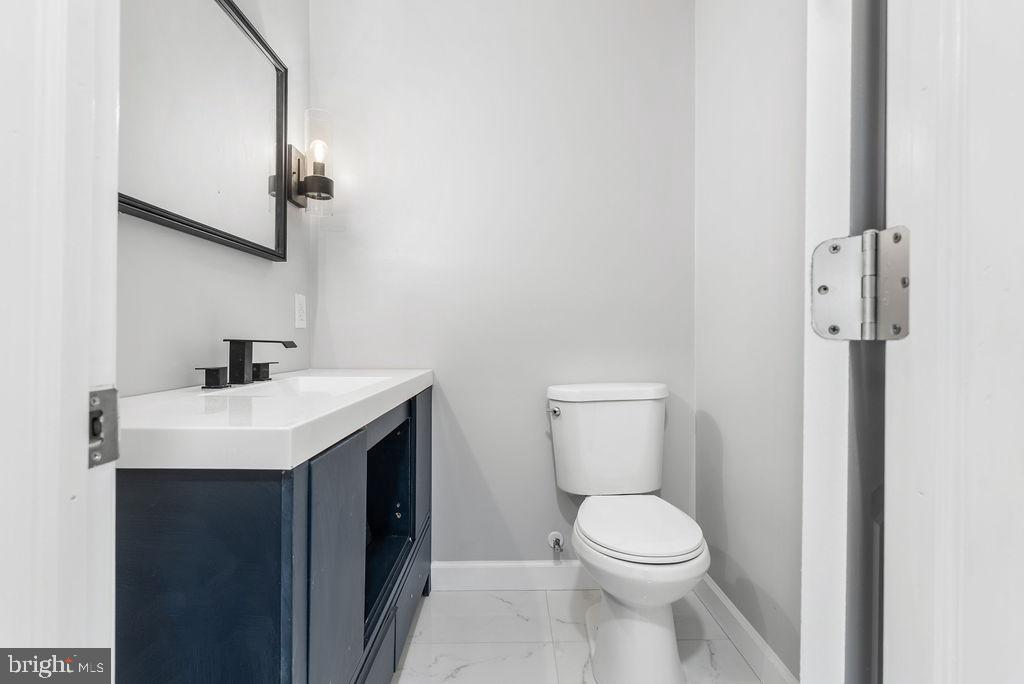 5034 Nash Street Northeast Washington, DC 20019 - Photo 12 of 36 a bathroom with a sink a toilet and a mirror