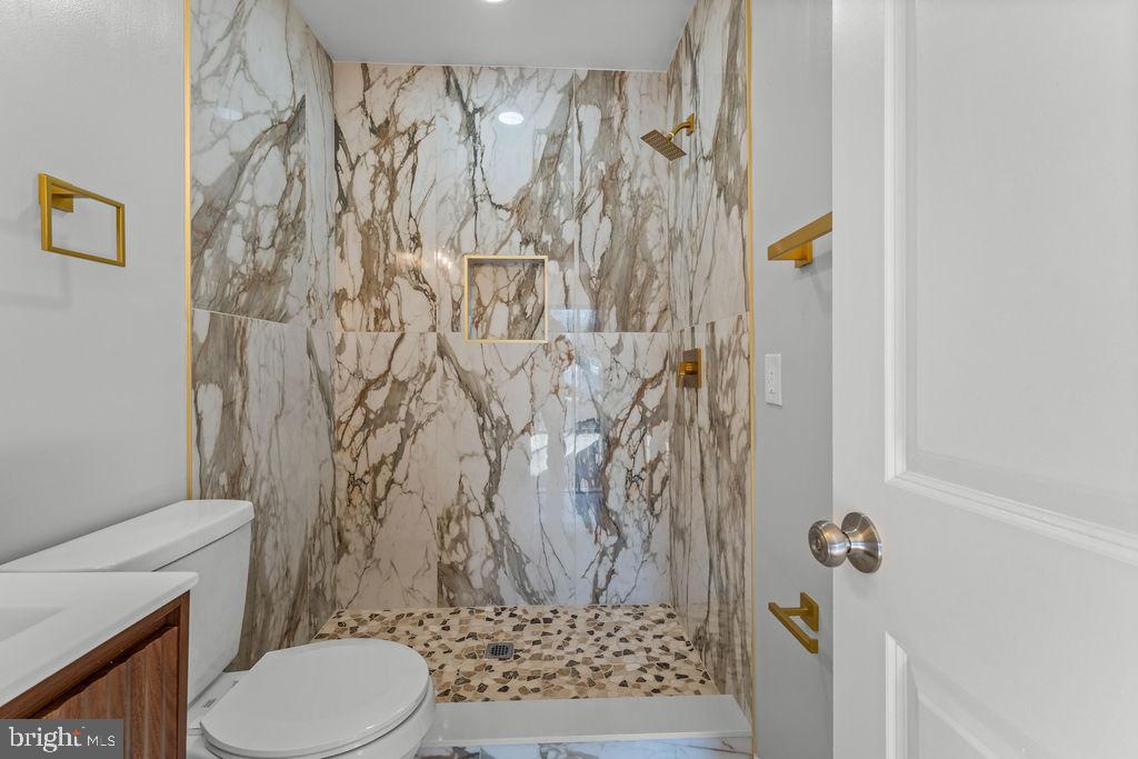 5034 Nash Street Northeast Washington, DC 20019 - Photo 16 of 36 a bathroom with a toilet and shower curtain
