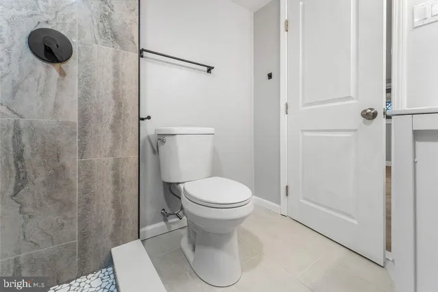 a white toilet sitting next to a bathroom sink