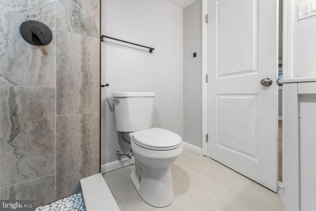 5034 Nash Street Northeast Washington, DC 20019 - Photo 31 of 36 a white toilet sitting next to a bathroom sink