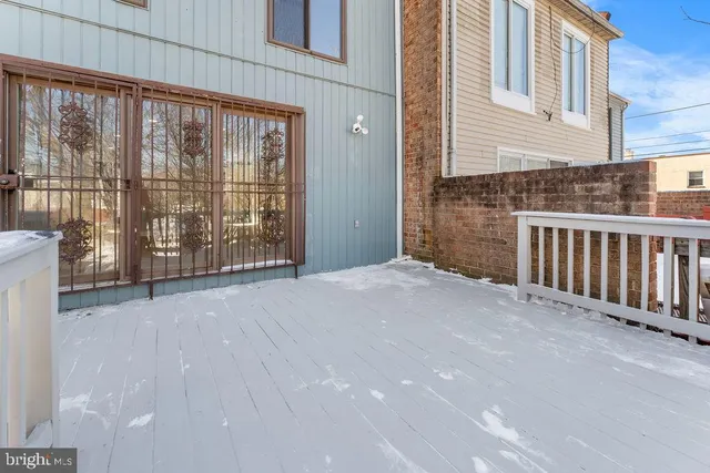 a view of a brick house with large windows