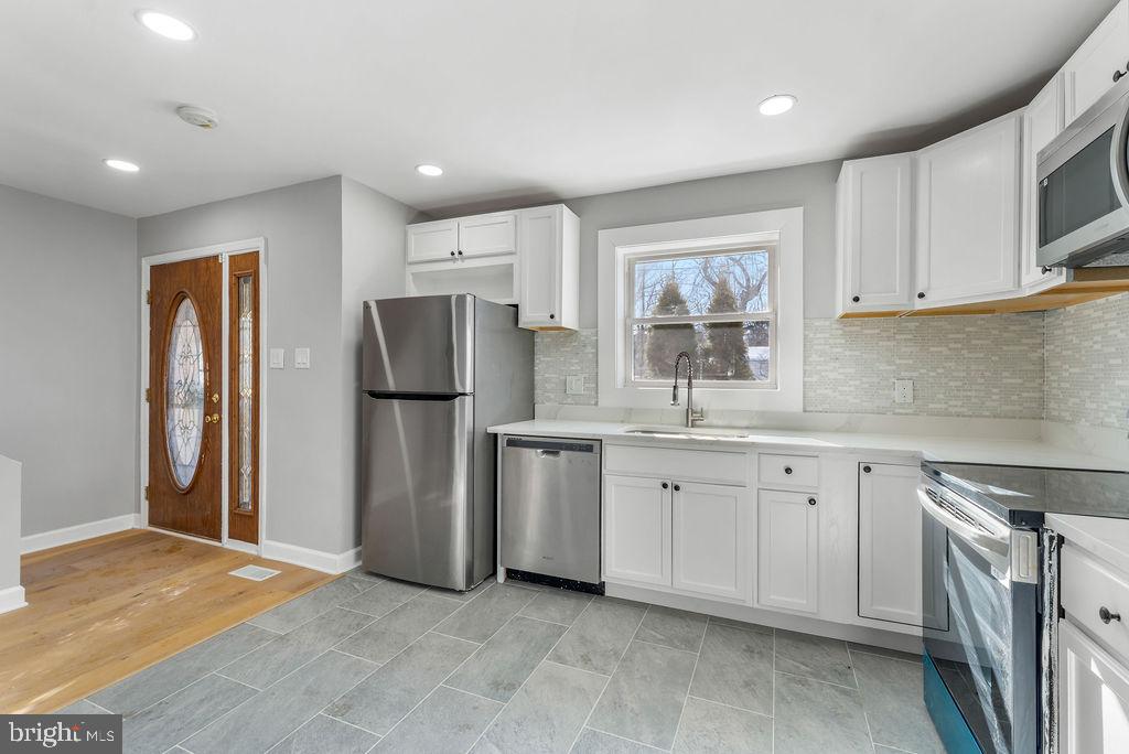 5034 Nash Street Northeast Washington, DC 20019 - Photo 6 of 36 a kitchen with refrigerator cabinets and a sink