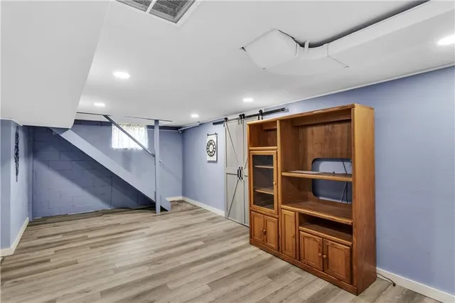 a view of an empty room with closet and a window