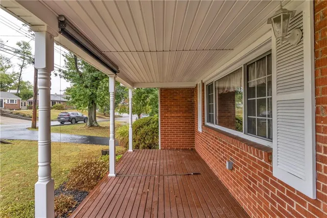 a view of a room with wooden floor and floor to ceiling window