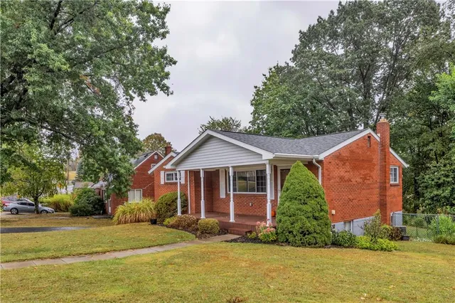 a front view of house with yard and green space