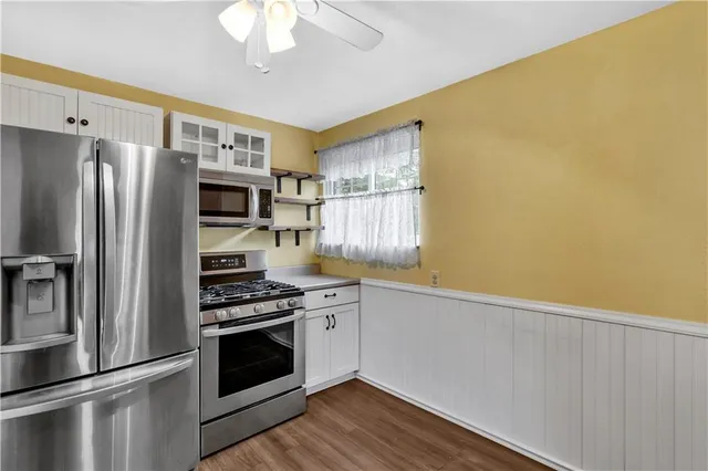 a kitchen with stainless steel appliances a refrigerator and a stove top oven