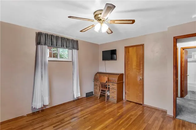 a view of room with window and wooden floor