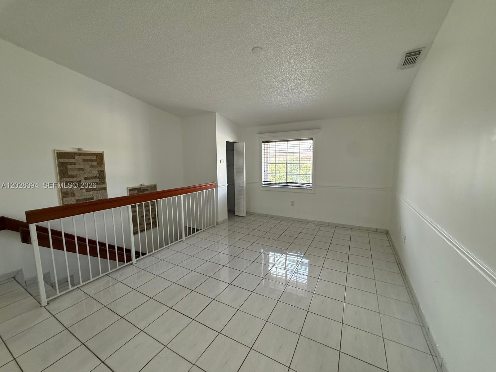 2212 West 74th Street, Unit 20128 Hialeah, FL 33016 - Photo 5 of 11 a view of an empty room and window