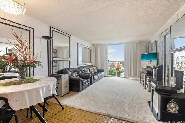 a living room with furniture a large window and wooden floor