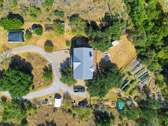 an aerial view of a house with a yard and garden