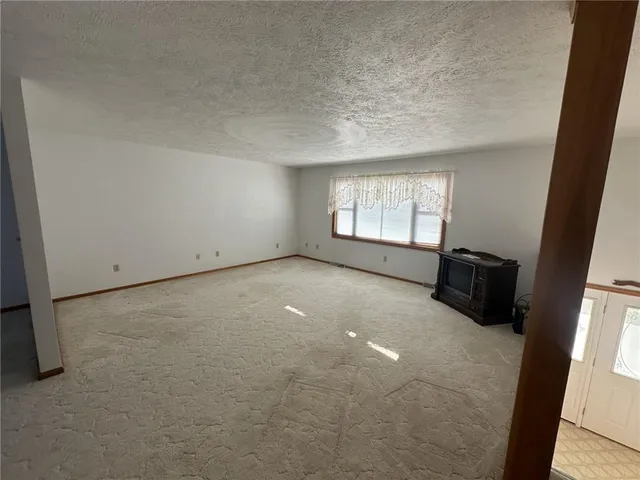 a kitchen with stainless steel appliances kitchen island granite countertop a sink and a refrigerator